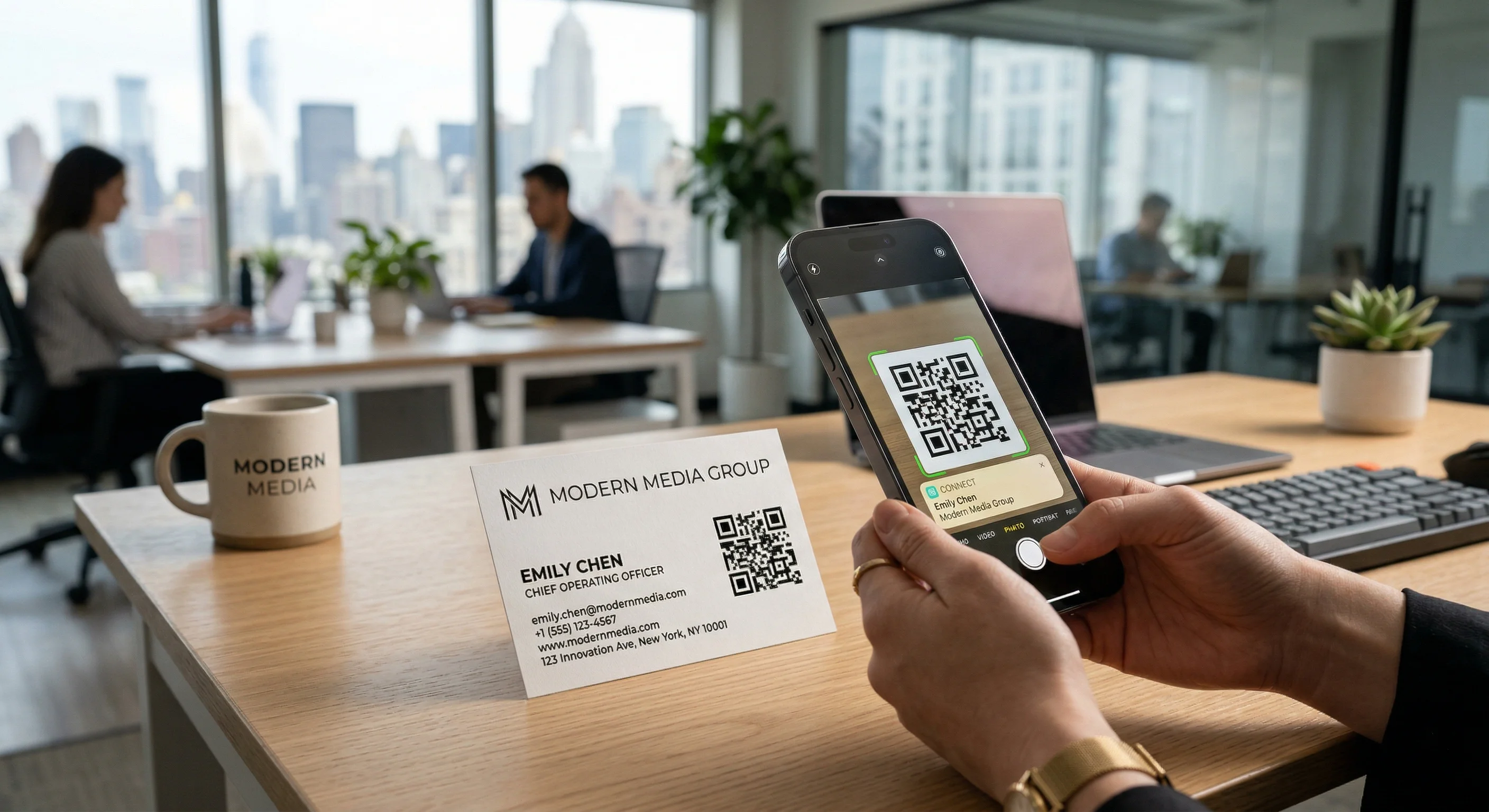 Professional business card with QR code being scanned by smartphone in modern office environment